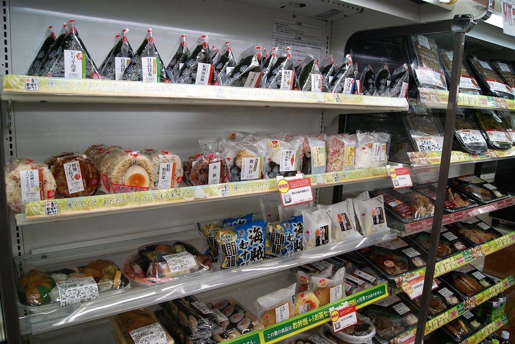 Konbini convenience store in tokyo japan with onigiri and hot food on the shelves tokyo travel guide